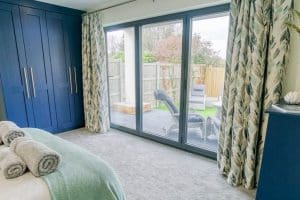 Madrona_Valley_Anglesey_double_bedroom_ensuite_french-windows_garden-view_3_1920x1080